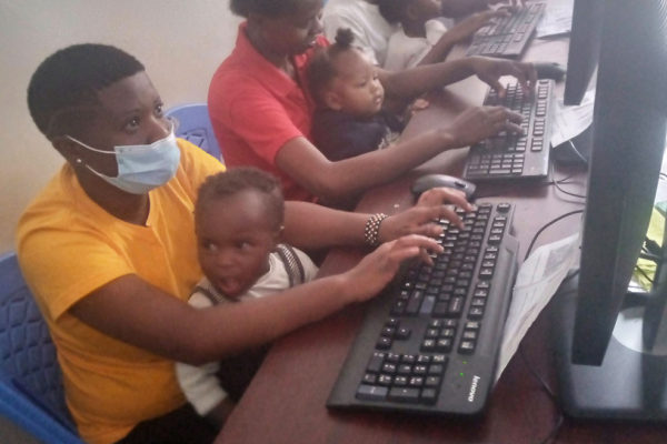 Teens at computers with babies
